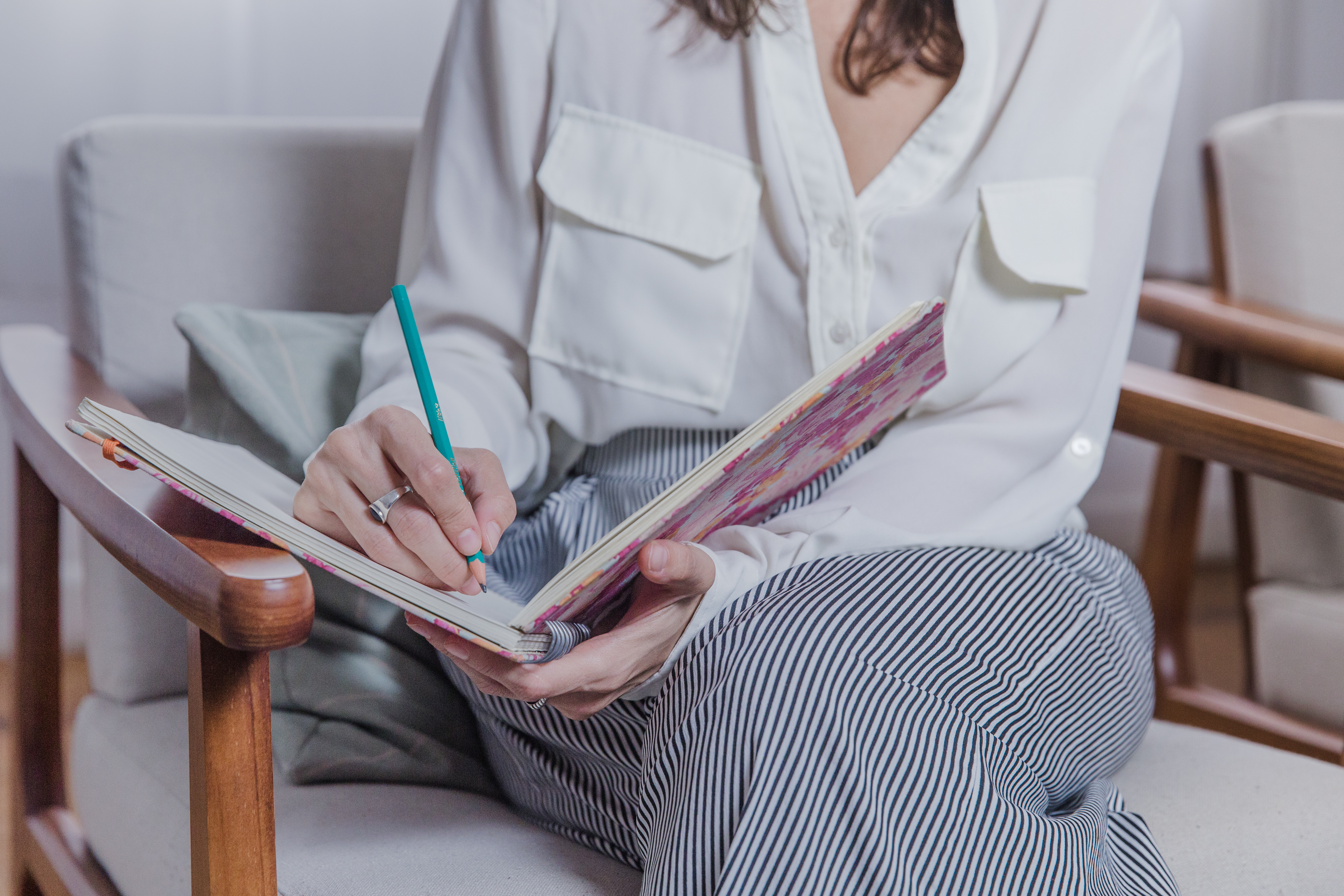 Person writing during a reflective therapy exercise